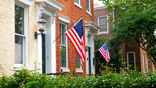 American flags decorating elegant brick townhouses in Capitol Hill Washington DC residential neighborhood