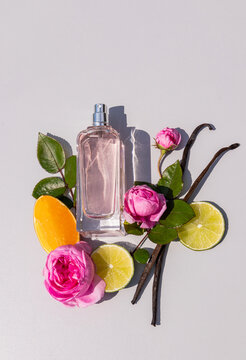 Perfume bottle with rose, citrus and vanilla flat lay