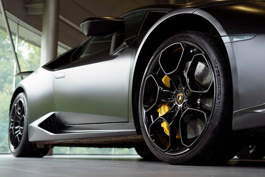 Moscow, Russia - July 25, 2026: Lamborghini Hurac&aacute;n at the car dealership. A close-up of a cast wheel is shown. The interior of the car dealership is shown in the background. The background is blurred