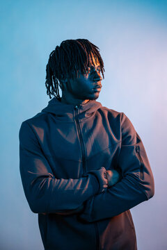 African man in hoodie with crossed arms in studio