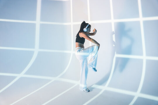 Latin woman dance in futuristic light projection studio