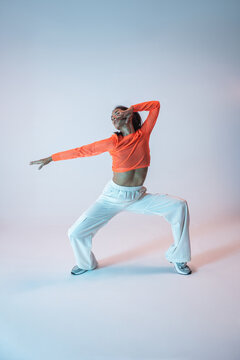 Latin woman dancer in expressive urban dance pose