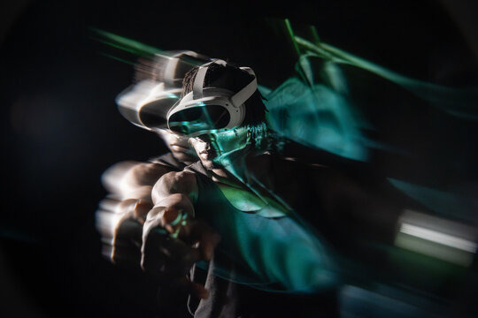 African man using VR headset with neon motion blur effect