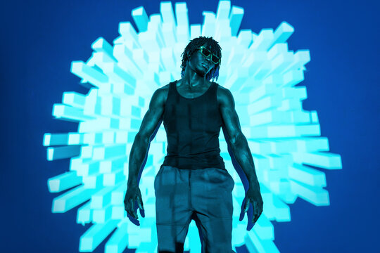 African man in futuristic neon light with 3D abstract wall