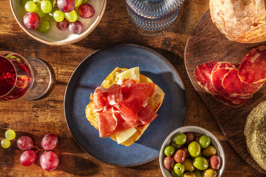 Rustic Mediterranean tapas with wine, bread and cured ham