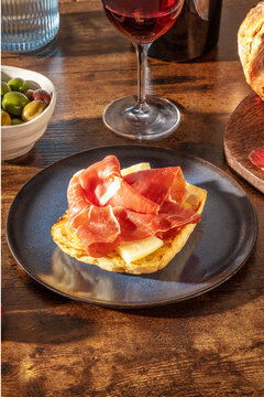 Rustic tapas with cured ham, bread and red wine