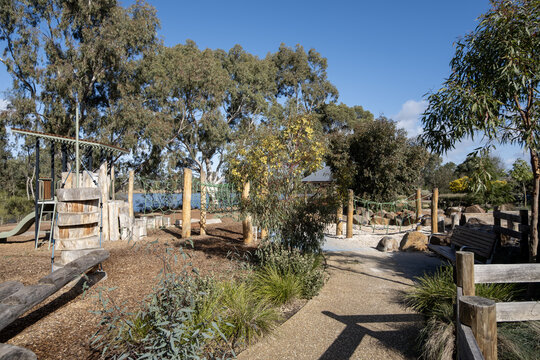 Nature-inspired playground blending with native vegetation at Melton Botanic Garden,  kid-friendly adventure play surrounded by eucalyptus trees and natural bushland in Victoria, Australia