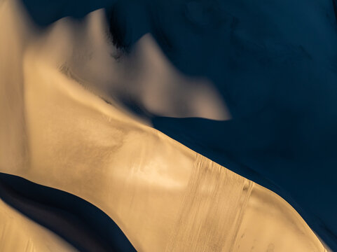Abstract dune pattern with sand texture and deep shadow