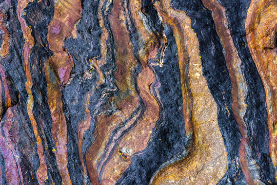 Abstract metamorphic rock texture with folded stone veins