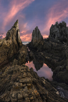 Asturian rocky coast at sunset with tide pool reflection