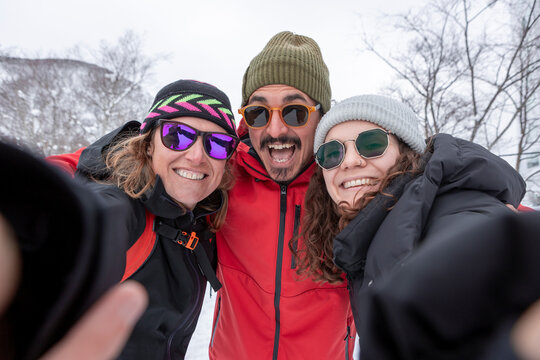 Winter selfie of friends having fun outdoors in snow