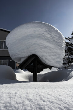 Massive Snow Cap on Wooden Structure in Niseko Japan