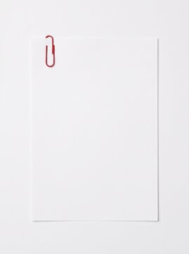Red paper attached to blank white page with stationery business background