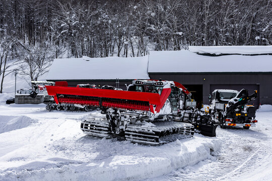 Snow groomer preparing fresh powder slopes at ski resort