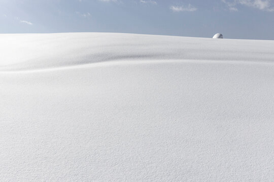 Pristine snowdrift in Japan under soft winter sky