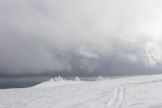 Snow-covered mountain ridge in Japan under stormy sky