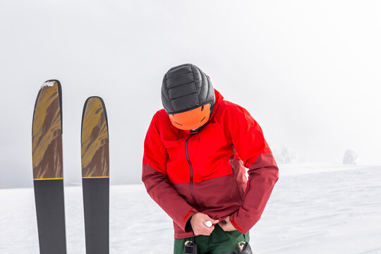 Splitboarder adjusting bindings in Japanese powder snow