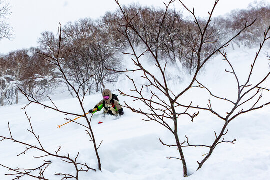 Skier navigating fresh powder in Hokkaido, Japan