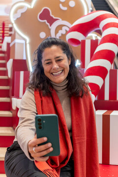 Woman taking festive selfie at holiday display in china