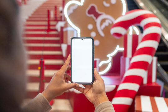 Smartphone mockup in festive holiday mall candy decor