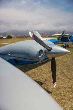Small aircraft propeller on grass field
