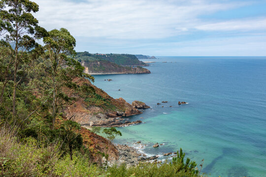 Coastal cliff viewpoint over tranquil bay and rocky shore