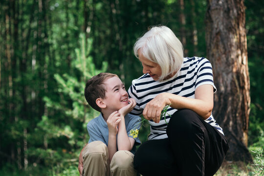 Grandmother and grandson sharing a moment in forest