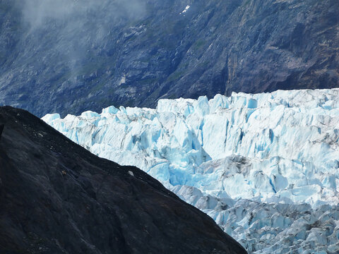 telephoto view of a section of the terminus of the beautiful white and blue Margerie Glacier in southeastern Alaska viewed from a cruise ship in July 2026