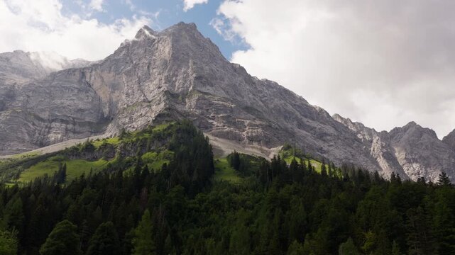 Dramatic rocky mountain peaks rising above alpine forest in Eng Alm Karwendel Austria