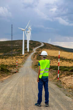 Renewable energy technician inspecting wind farm site