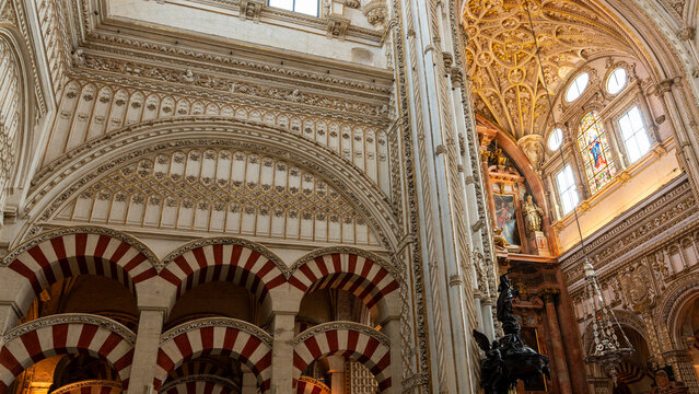 Ornate interior arches and chapel in Cordoba, Spain