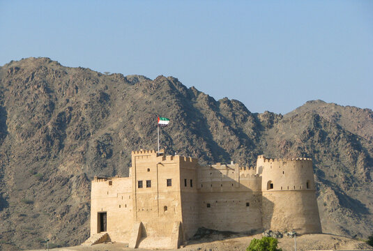 Bithnah Fort with UAE flag in Hajar Mountains, Fujairah UAE