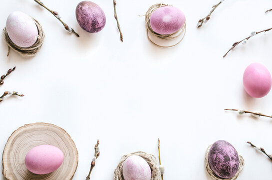 Pastel Easter eggs and spring branches on white background
