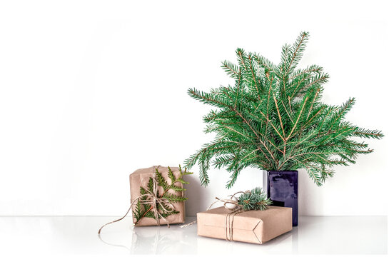 Minimal Christmas table scene with spruce and gifts mock-up
