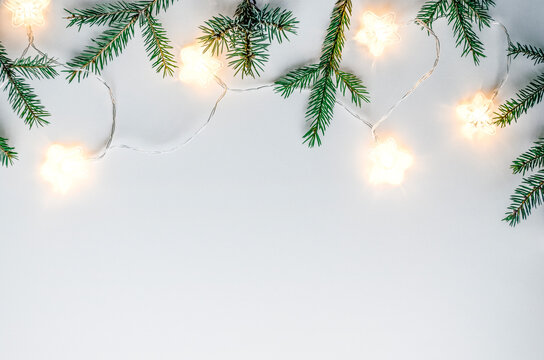 Cozy Christmas flat lay with fir branches and star lights