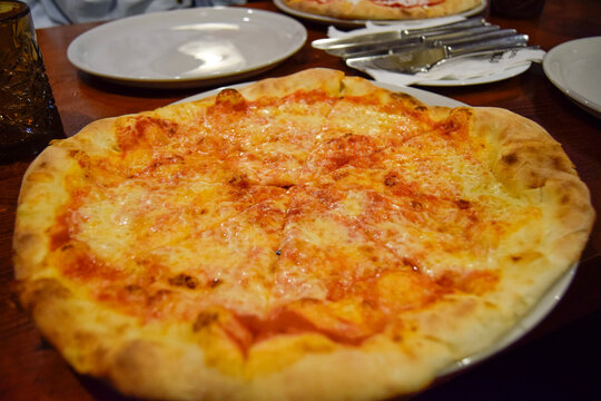 Cheesy pizza on a restaurant table