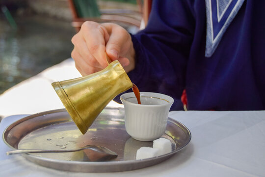 Traditional turkish coffee being poured into a cup