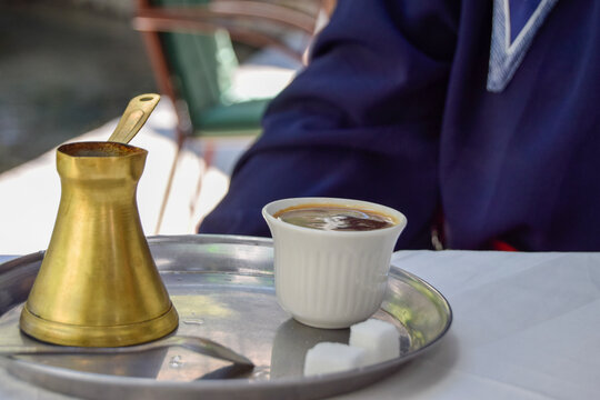 Traditional Turkish coffee served with a brass cezve