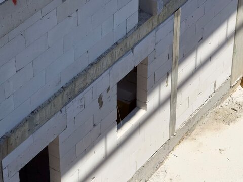 Unfinished aerated concrete block wall with window openings