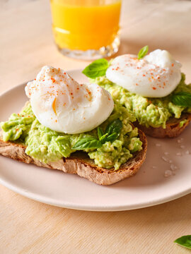 Avocado sandwich brunch with poached egg and juice