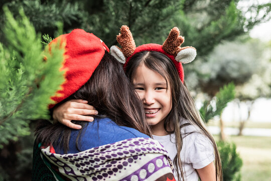 Mother and daughter hugging in Christmas spirit