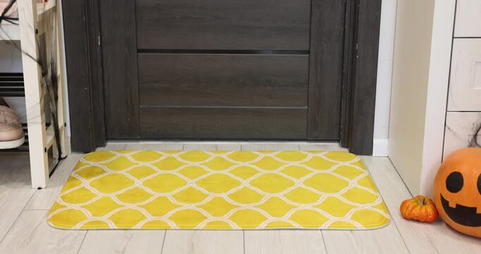 Stylish patterned doormat on floor near entrance indoors. Camera moving forward