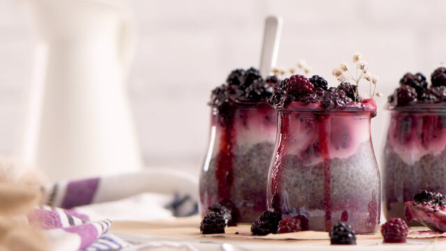 Chia seed pudding jars layered with blackberry compote and cream