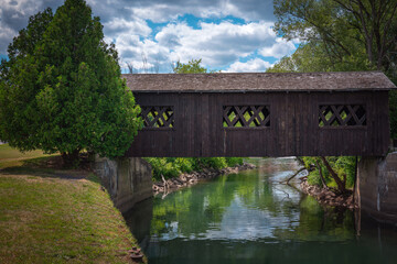 Fototapeta premium Ticonderoga Kissing Bridge historical landmark architecture crossing the La Chute River in Ticonderoga, New York, USA