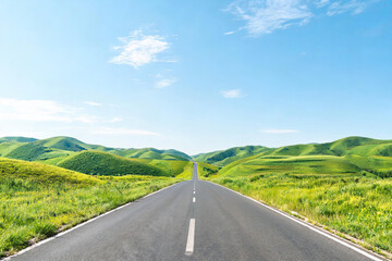 Obraz premium A straight asphalt highway stretches through lush green rolling hills under a clear bright blue sky with scattered clouds.