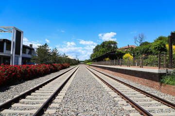 Fototapeta premium Scenery of Retro Cultural and Creative Park Railway Tracks and Platform Under Clear Blue Sky