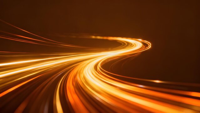 Golden light trails form a winding path against dark background capturing motion blur effect