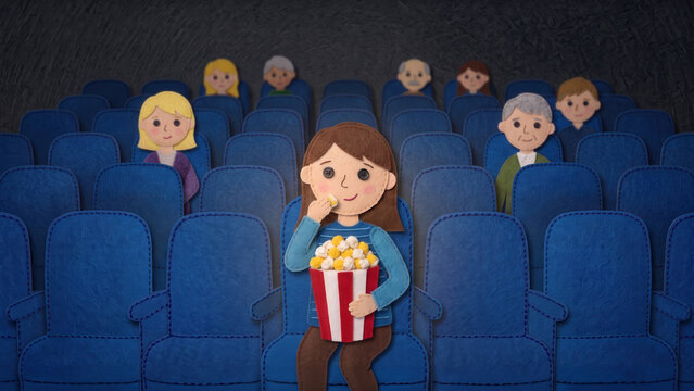 Handcrafted felt illustration of a woman eating popcorn in a movie theater, surrounded by blue seats and a scattered audience in a dim cinema.
