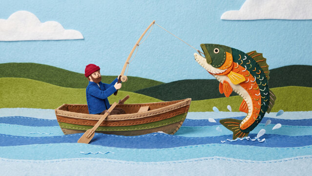 Handcrafted felt illustration of a man in a small boat catching a giant colorful fish leaping from the blue water against a backdrop of green hills.