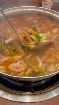Delicious spicy Korean army stew budae jjigae boiling